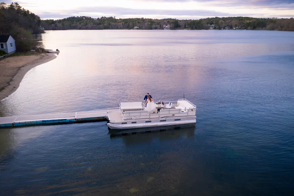 Aerial view of the pontoon boat at the dock on the pond